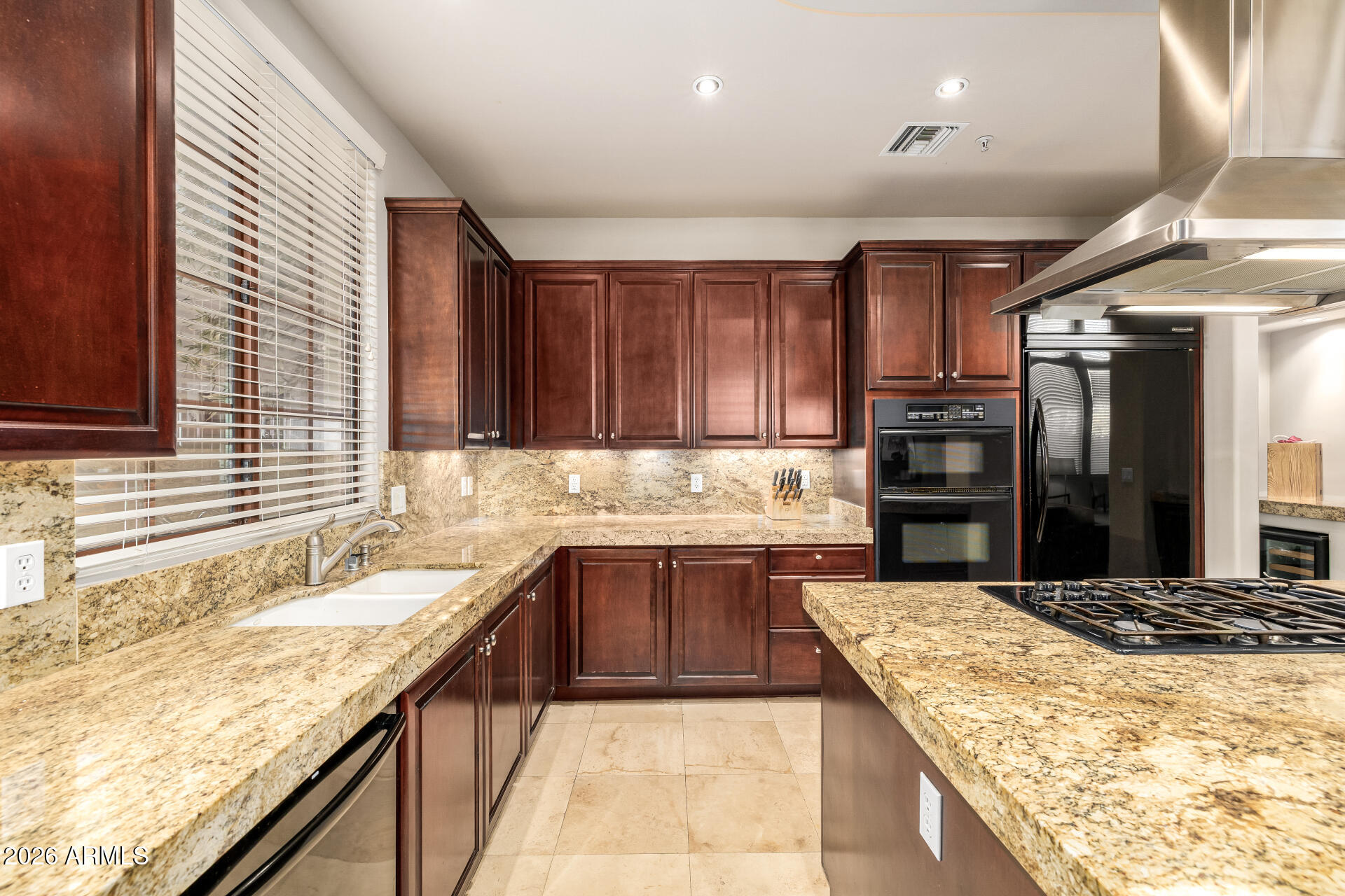 4430 North 22nd Street, Unit 3 Phoenix, AZ 85016 - Photo 18 of 68 a kitchen with stainless steel appliances granite countertop wooden cabinets a sink and dishwasher