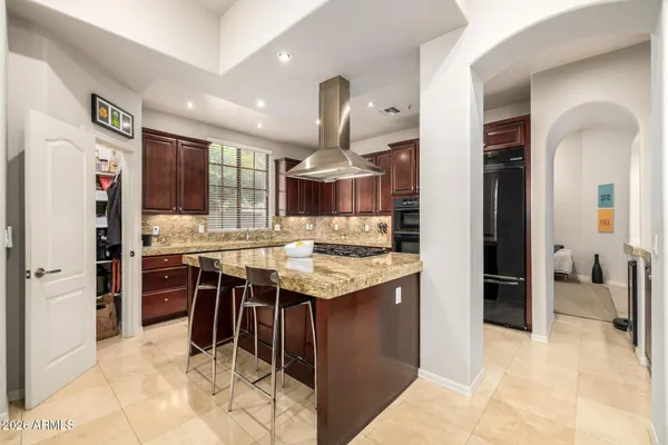 a bathroom with a granite countertop sink a mirror and a shower