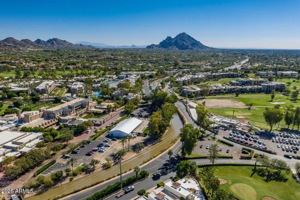 a kitchen with stainless steel appliances kitchen island granite countertop a refrigerator and a sink