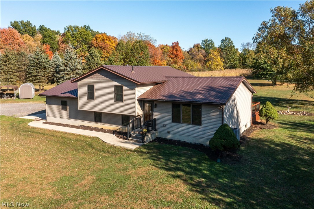 6760 Mason Road Berlin Heights, OH 44814 - Photo 2 of 49 Back of house with a metal roof and a yard