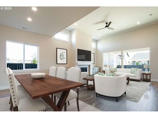 a living room with furniture a large window and a flat screen tv