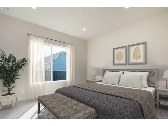 a bedroom with a large bed and a large window