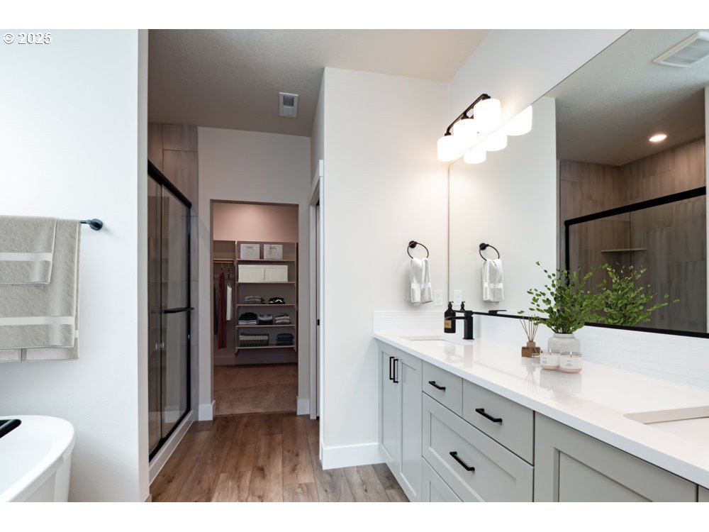 0 East Primavera Street Newberg, OR 97132 - Photo 6 of 8 a bathroom with a double vanity sink a mirror and a shower