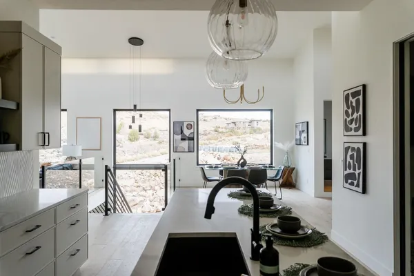 a view of a dining room with furniture a chandelier and wooden floor