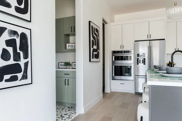 a kitchen with stainless steel appliances granite countertop a refrigerator and a stove top oven