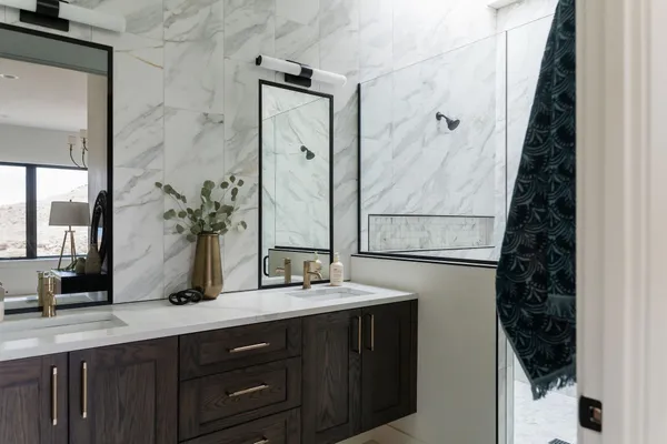 a bathroom with a double vanity sink and a mirror