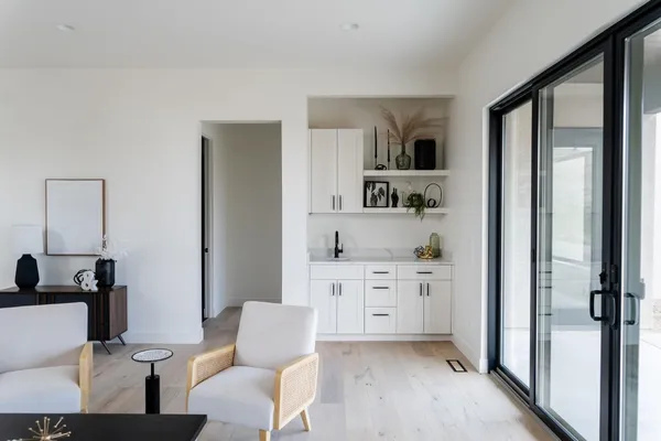 a kitchen with white cabinets and black stainless steel appliances