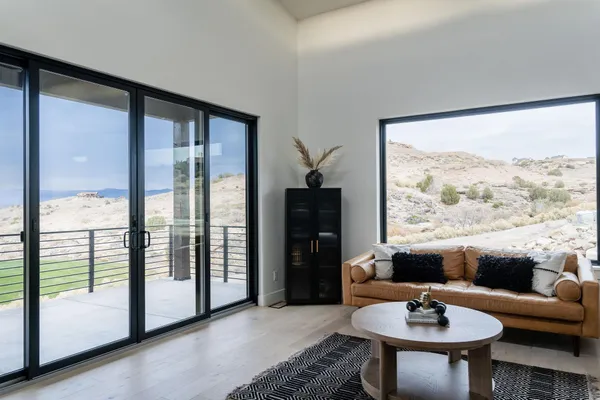 a living room with furniture and a floor to ceiling window