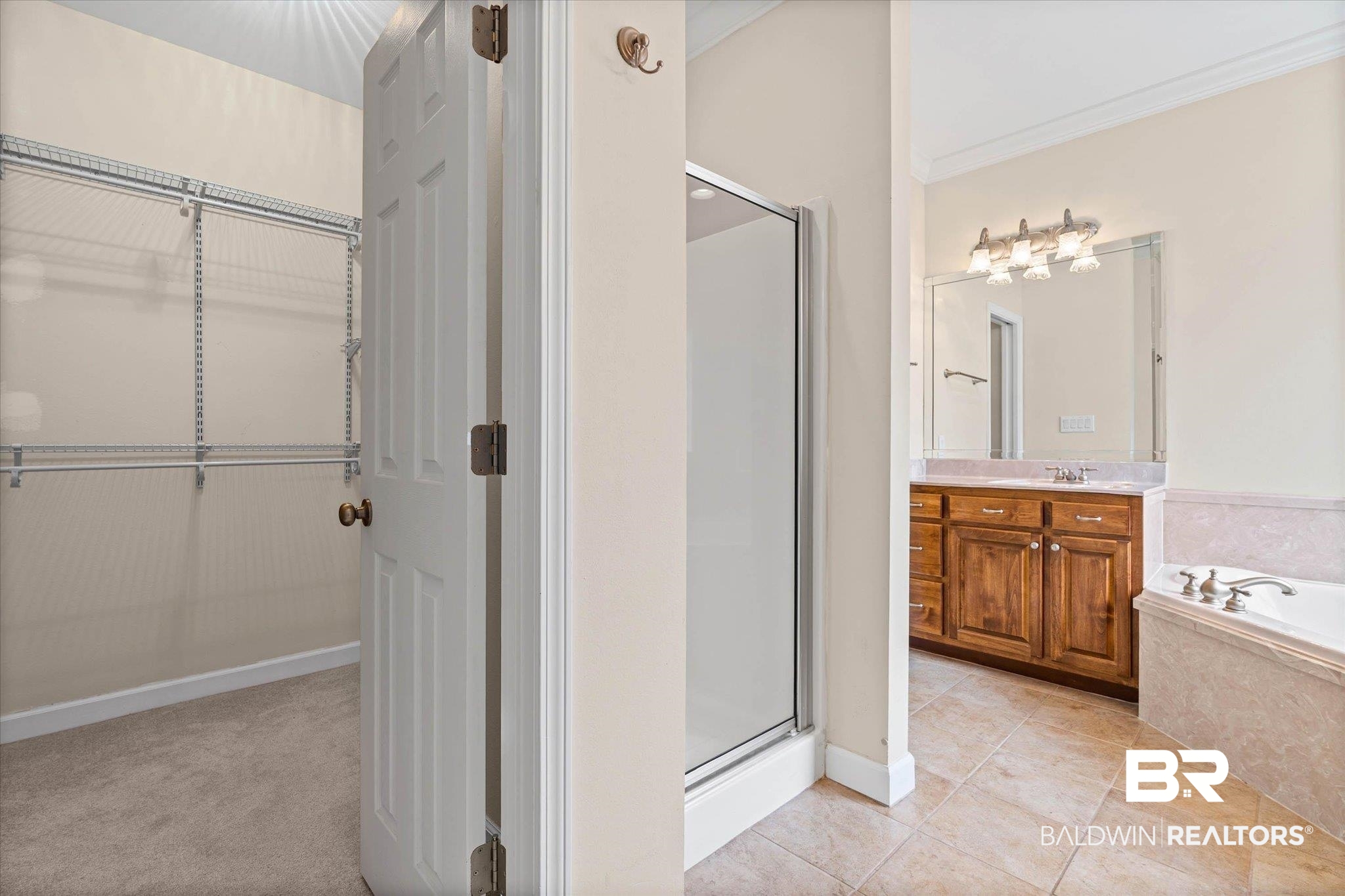 1003 Weatherby Street South Saraland, AL 36571 - Photo 25 of 31 Bathroom with vanity, a walk in closet, crown molding, a shower stall, and a bath