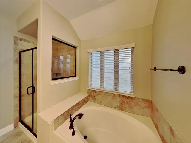 a bathroom with a tub and a window