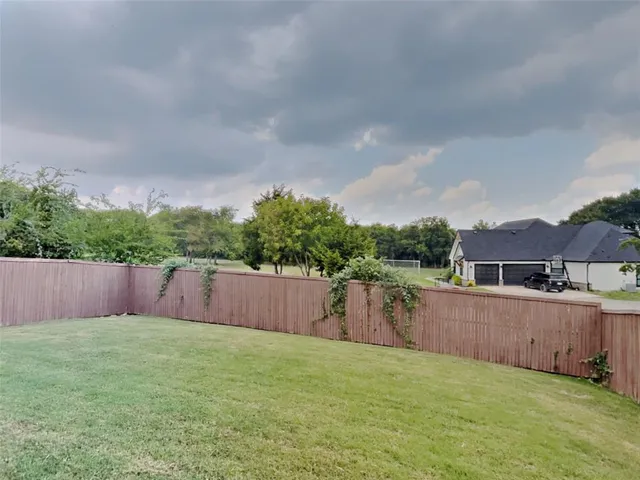 an empty room with fireplace and windows