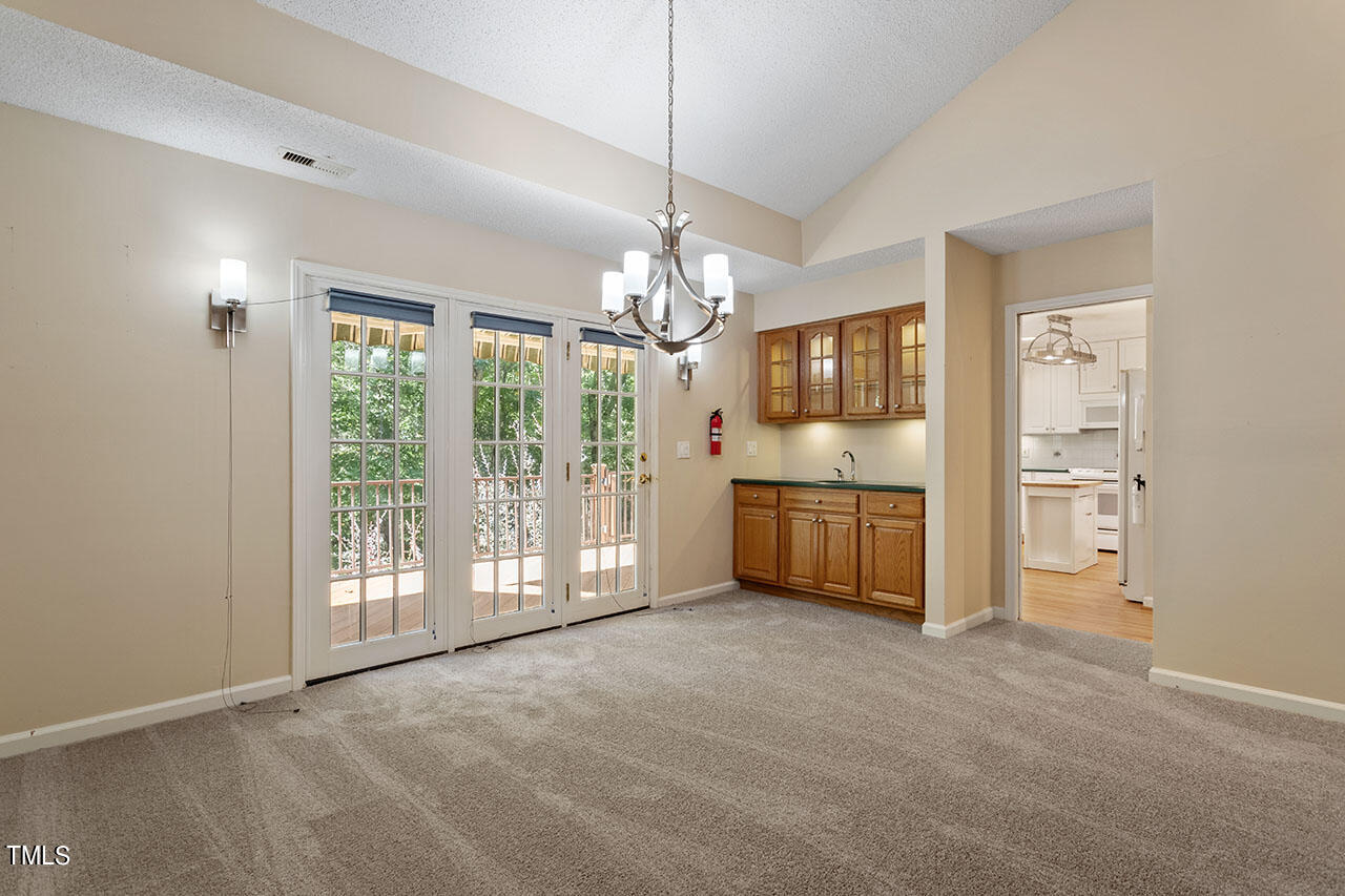 3124 Coachman's Way Durham, NC 27705 - Photo 11 of 30 a view of a kitchen with a stove cabinets and a chandelier
