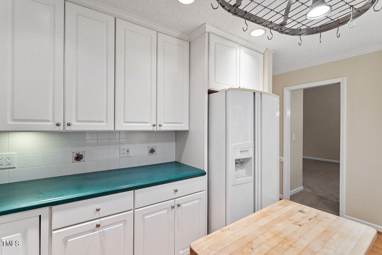 3124 Coachman's Way Durham, NC 27705 - Photo 15 of 30 a kitchen with white cabinets and refrigerator