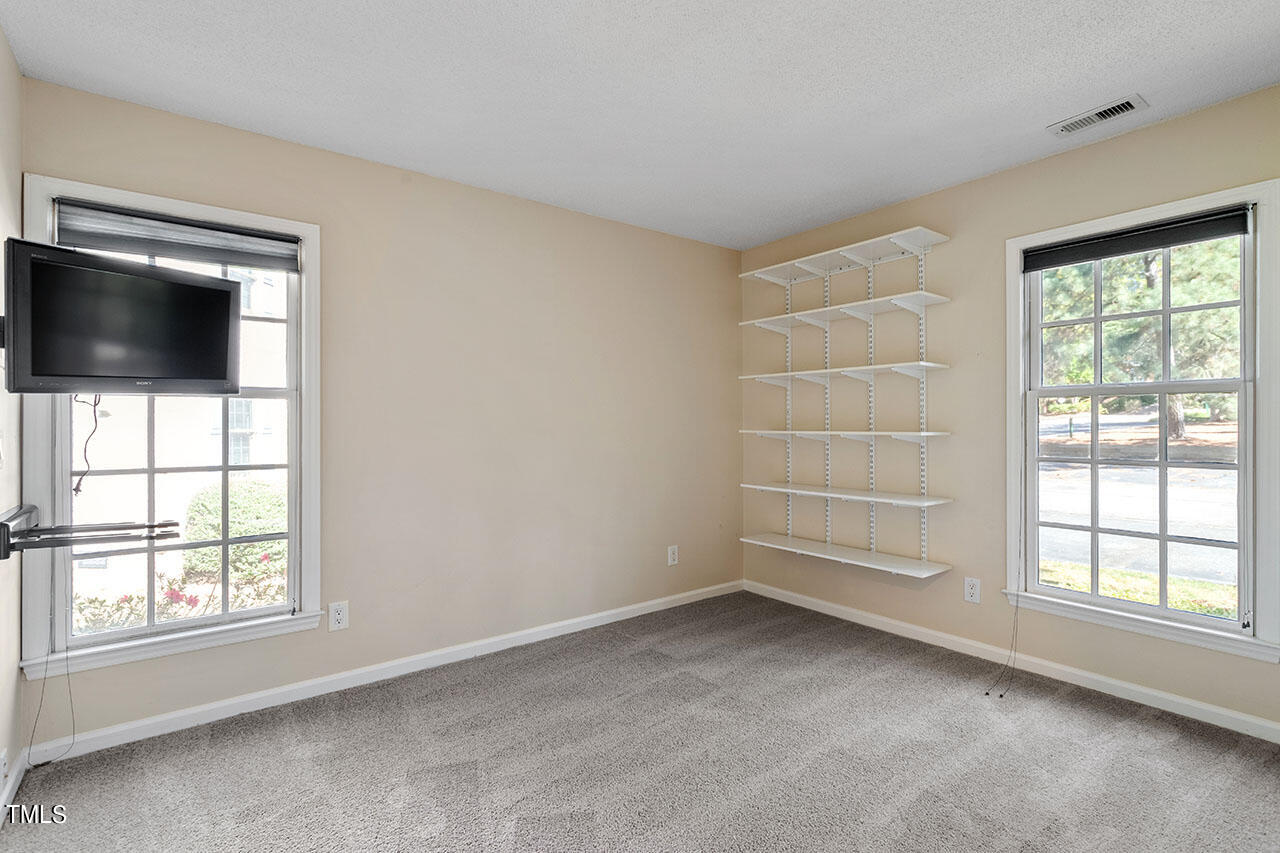 3124 Coachman's Way Durham, NC 27705 - Photo 22 of 30 an empty room with windows and flat screen tv
