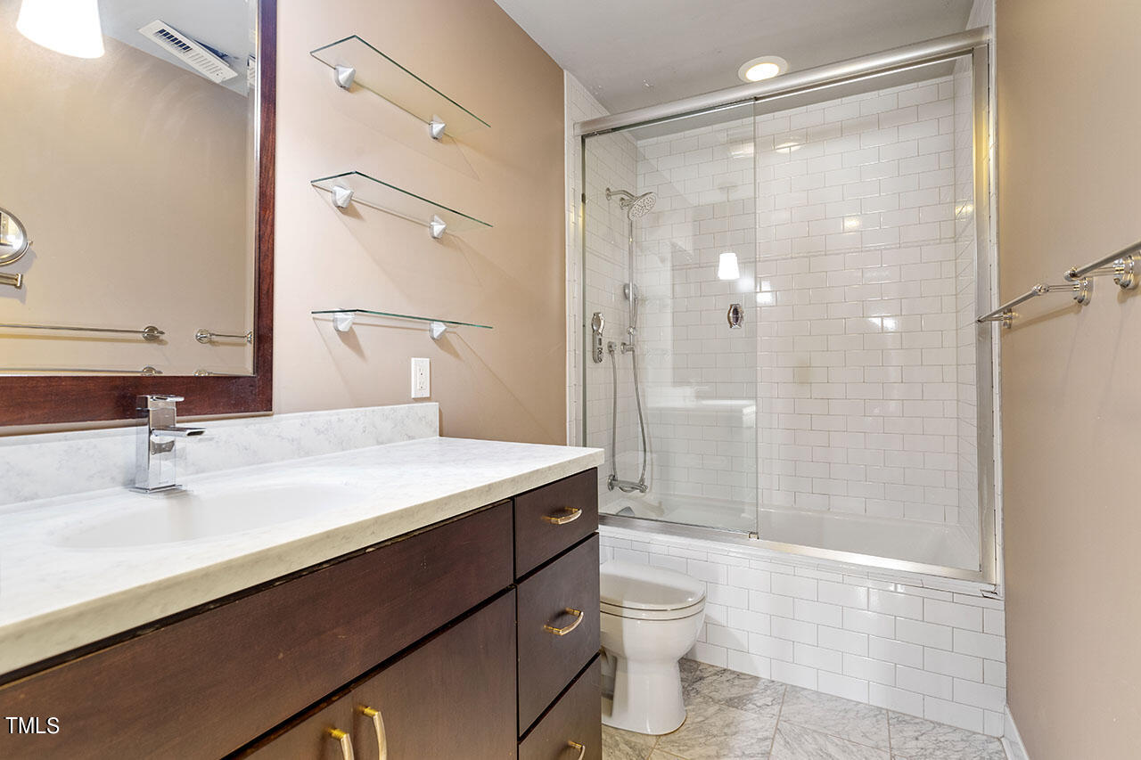 3124 Coachman's Way Durham, NC 27705 - Photo 24 of 30 a bathroom with a sink a toilet and shower
