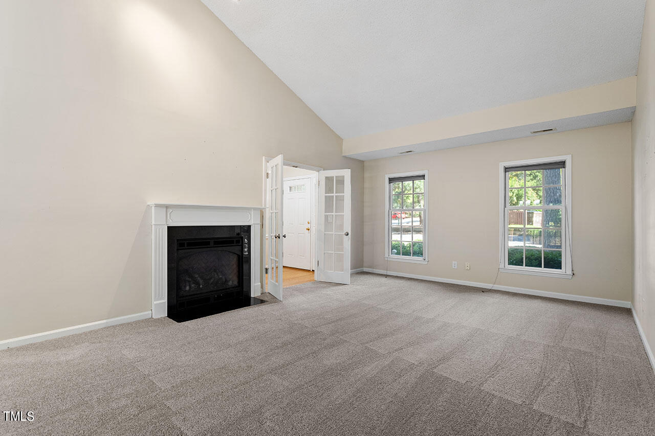 3124 Coachman's Way Durham, NC 27705 - Photo 9 of 30 an empty room with windows and fireplace