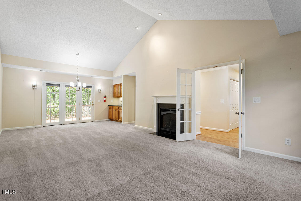 3124 Coachman's Way Durham, NC 27705 - Photo 10 of 30 a view of an empty room with a fireplace and a window