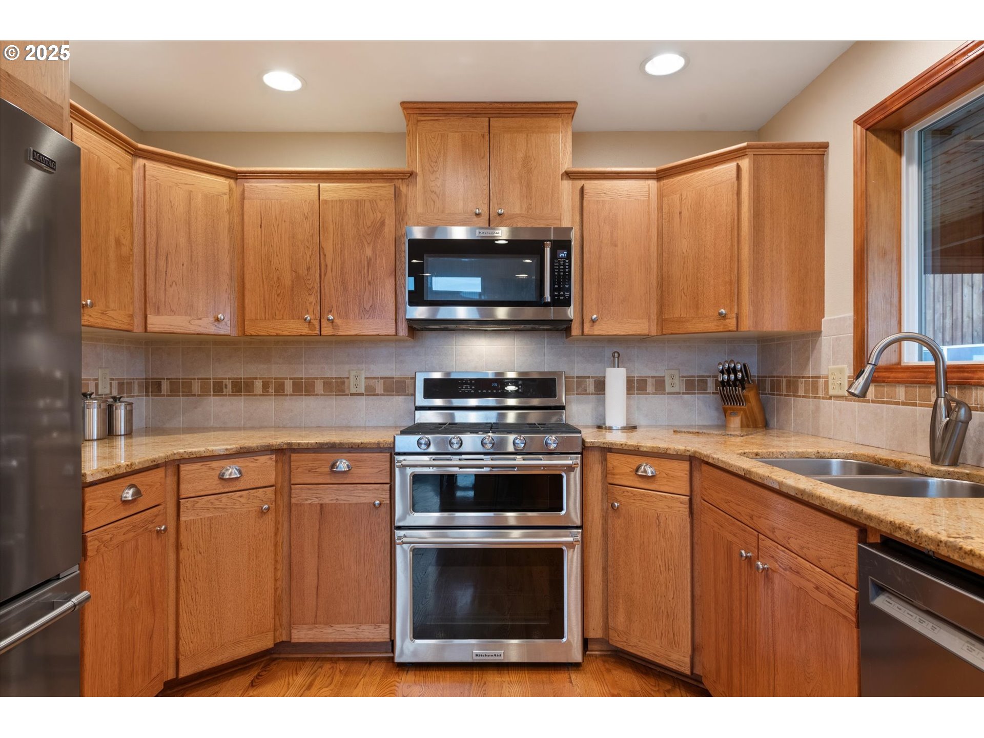 62123 Chandler Loop La Grande, OR 97850 - Photo 21 of 48 a kitchen with stainless steel appliances granite countertop a stove a sink and a microwave
