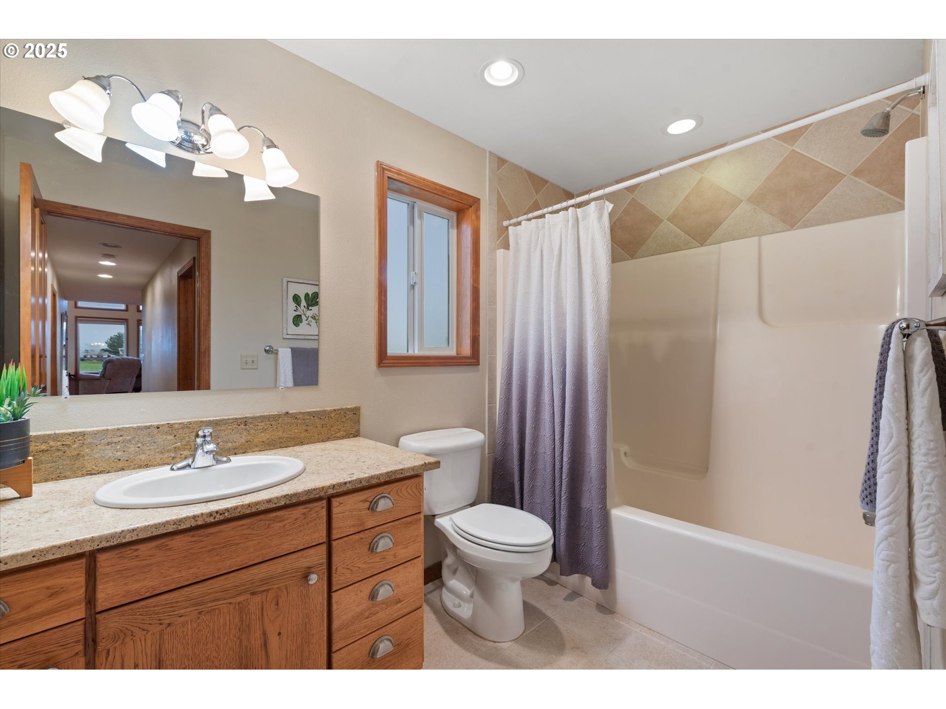 62123 Chandler Loop La Grande, OR 97850 - Photo 31 of 48 a bathroom with a sink a toilet a mirror a vanity and shower