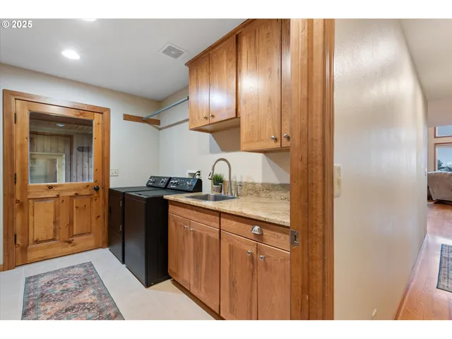 a kitchen with granite countertop a refrigerator and cabinets