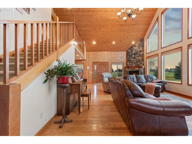 a living room with furniture a potted plant and a table
