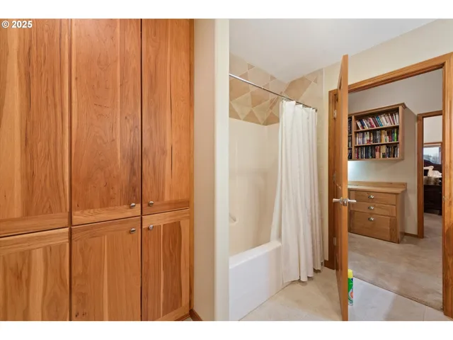 a bathroom with a shower and a room