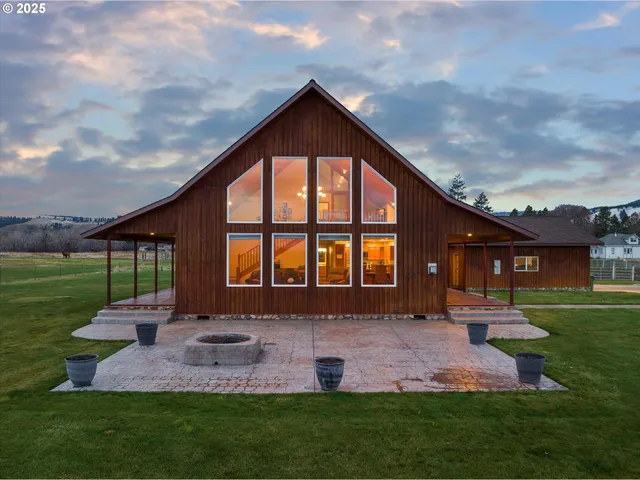 a front view of house with yard and outdoor seating