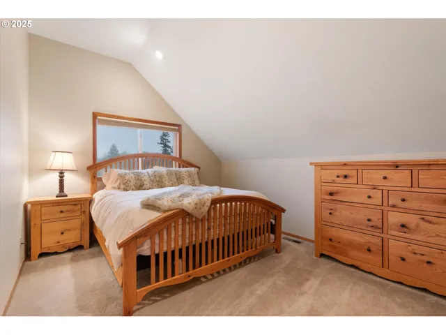 a bedroom with a bed and a night stand