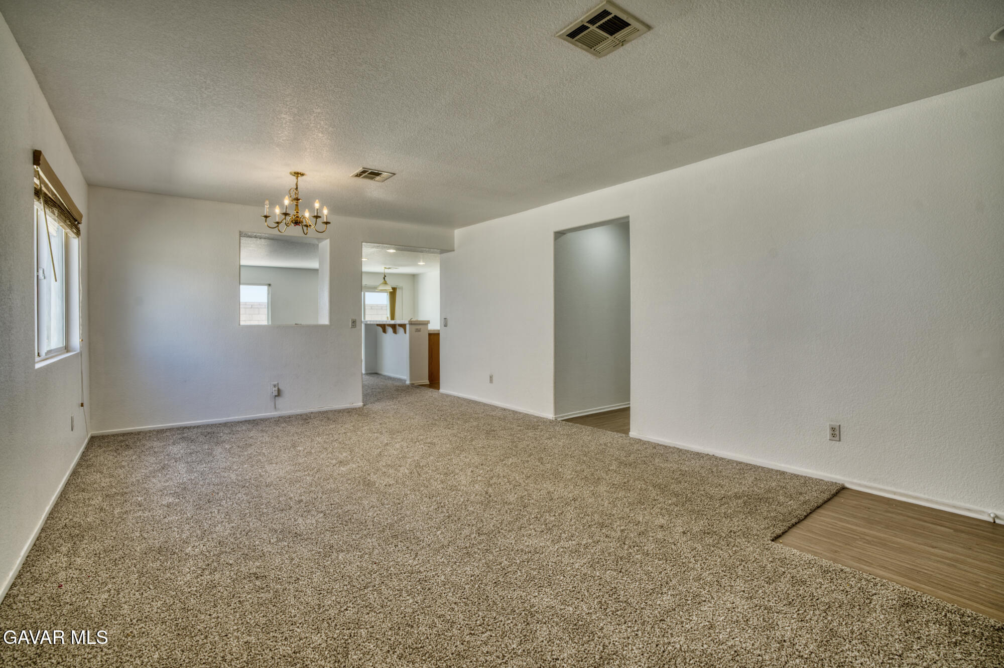 45444 Spahn Lane Lancaster, CA 93535 - Photo 2 of 13 an empty room with chandelier fan and windows