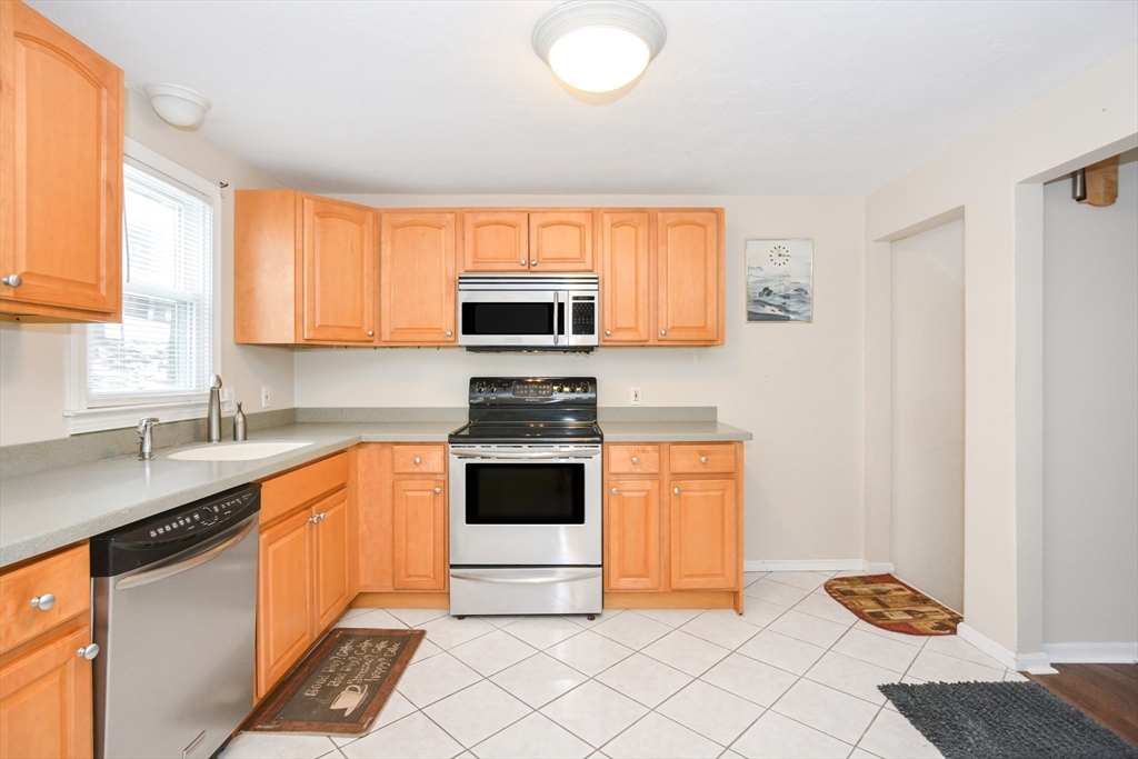 2 Hartness Road, Unit A Sutton, MA 01590 - Photo 11 of 37 a kitchen with stainless steel appliances granite countertop a stove a sink and a microwave