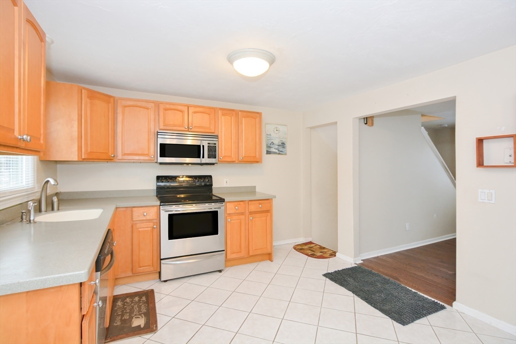 2 Hartness Road, Unit A Sutton, MA 01590 - Photo 12 of 37 a kitchen with stainless steel appliances a stove a sink and a microwave