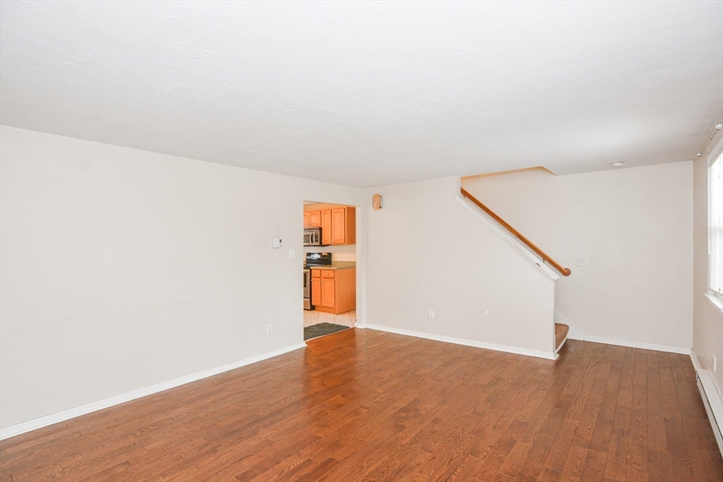 2 Hartness Road, Unit A Sutton, MA 01590 - Photo 22 of 37 a view of an empty room with wooden floor