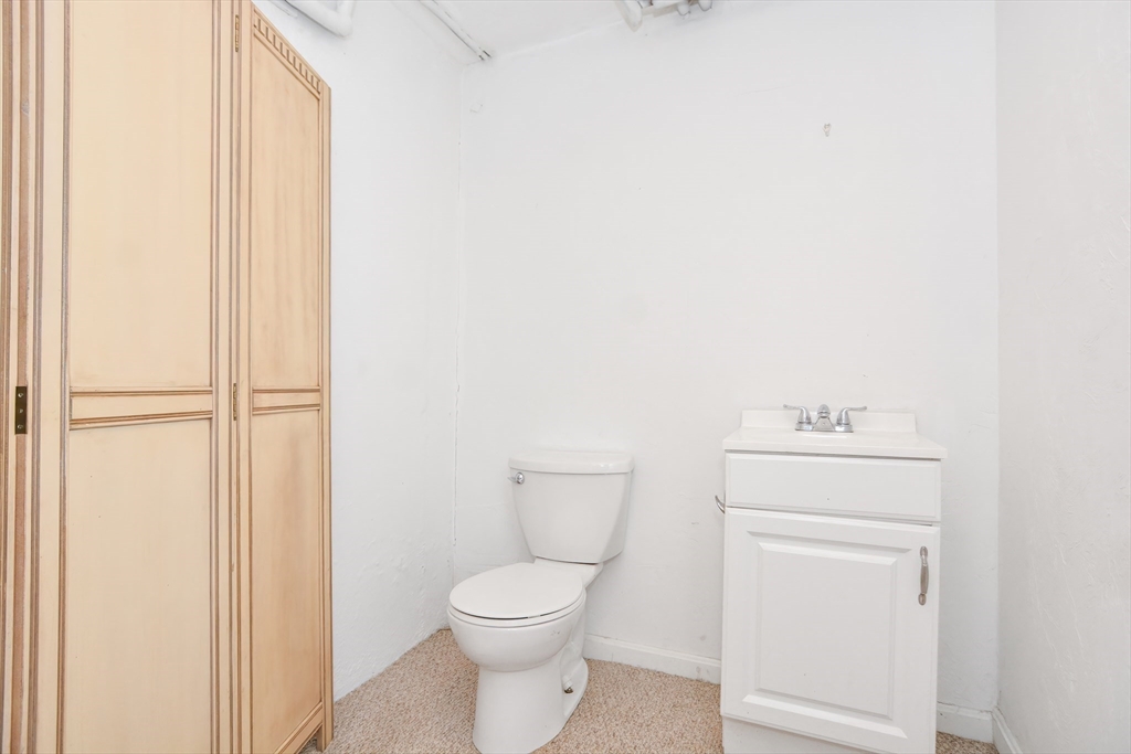 2 Hartness Road, Unit A Sutton, MA 01590 - Photo 6 of 37 a white toilet sitting next to a bathroom sink