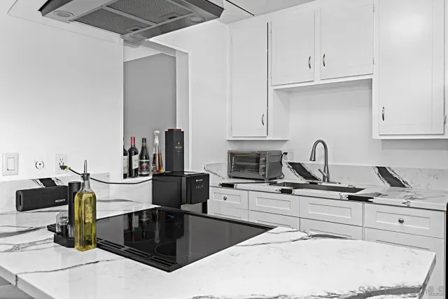 a kitchen with refrigerator and cabinets