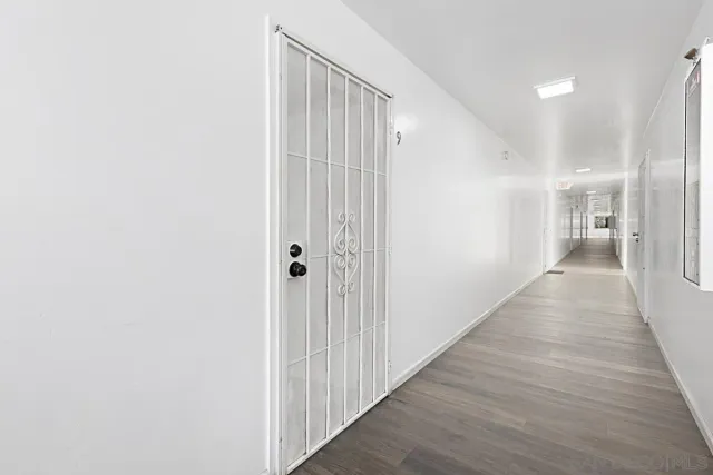 a view of a hallway with wooden floor