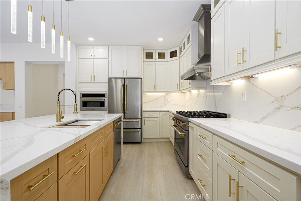 15 Plum Street Ladera Ranch, CA 92694 - Photo 23 of 113 a kitchen with stainless steel appliances granite countertop a stove a sink and a refrigerator
