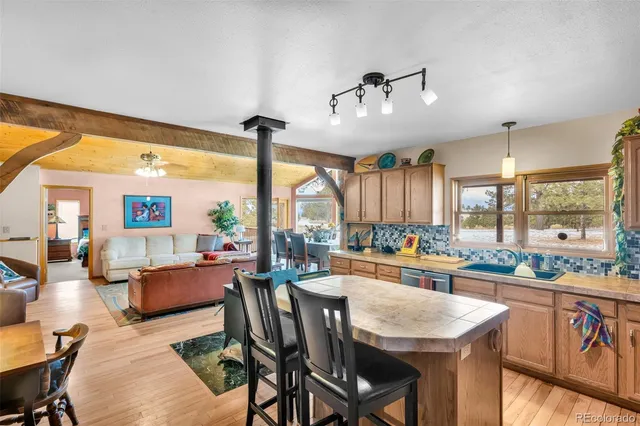 a view of a dining room with furniture large windows and wooden floor
