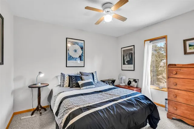 a bedroom with a bed and cabinet