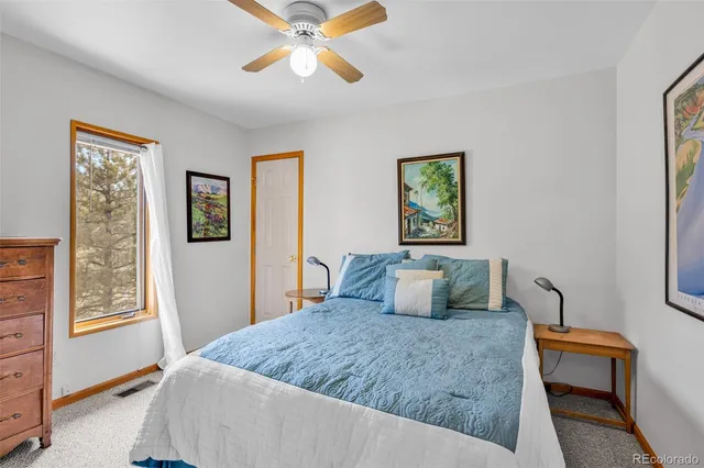 a bedroom with a large bed and a window