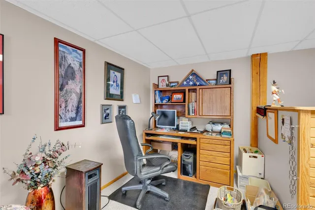 a view of a workspace with furniture and wooden floor