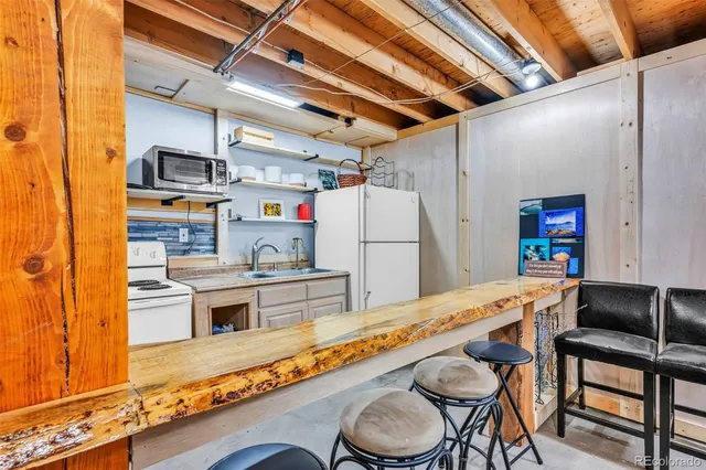 a kitchen with stainless steel appliances granite countertop a sink and refrigerator