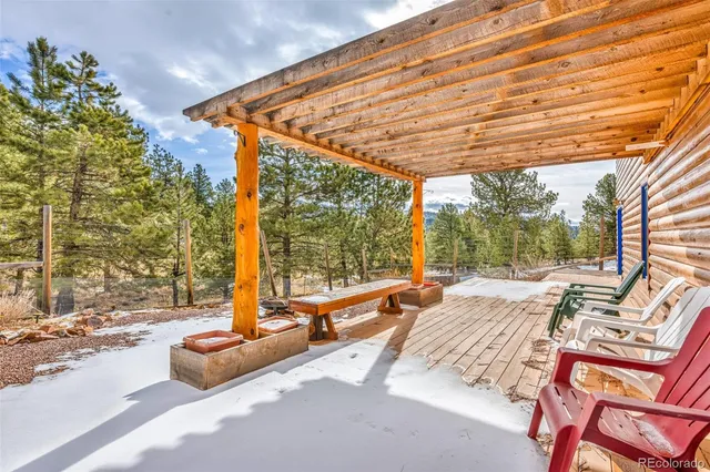 a view of a patio with a table and chairs under an umbrella
