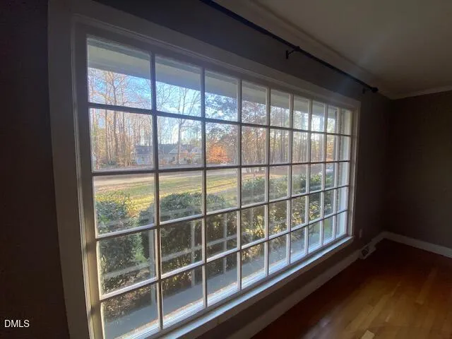 a view of a room with wooden floor and windows