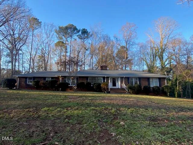 a view of house with outdoor space and swimming pool