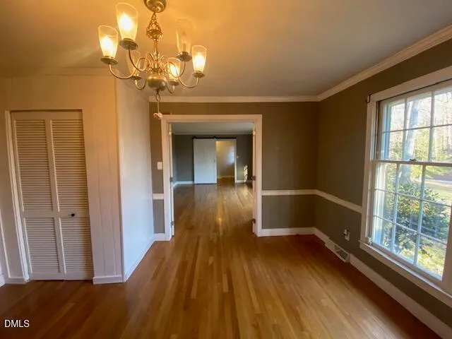 a view of a room with wooden floor