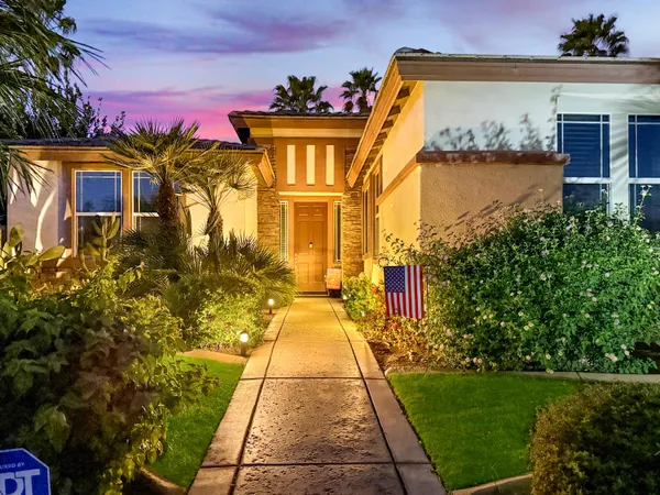 a front view of a house with garden