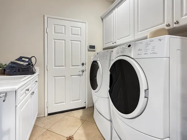 a front view of a house with a yard and potted plants