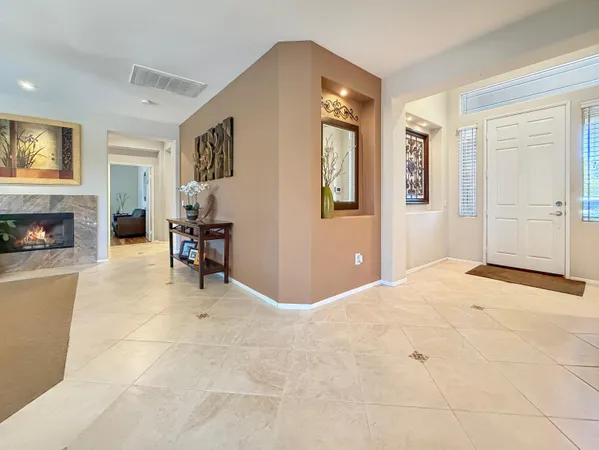 a living room with furniture and a ceiling fan