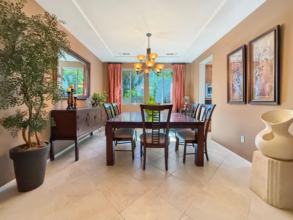 a spacious bedroom with a large bed and a chandelier