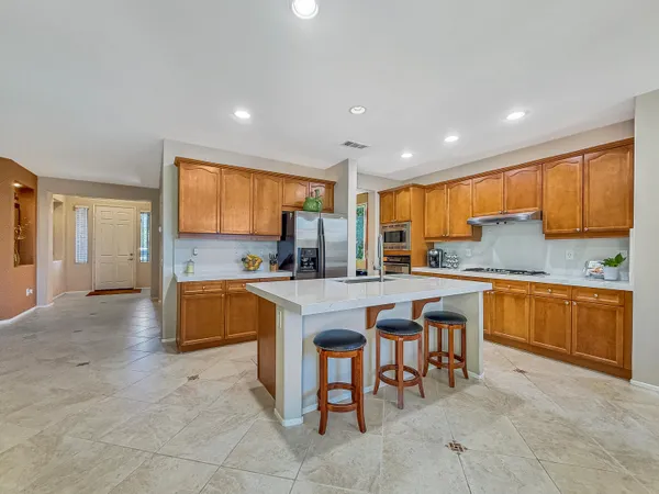 a large kitchen with kitchen island a large counter top space